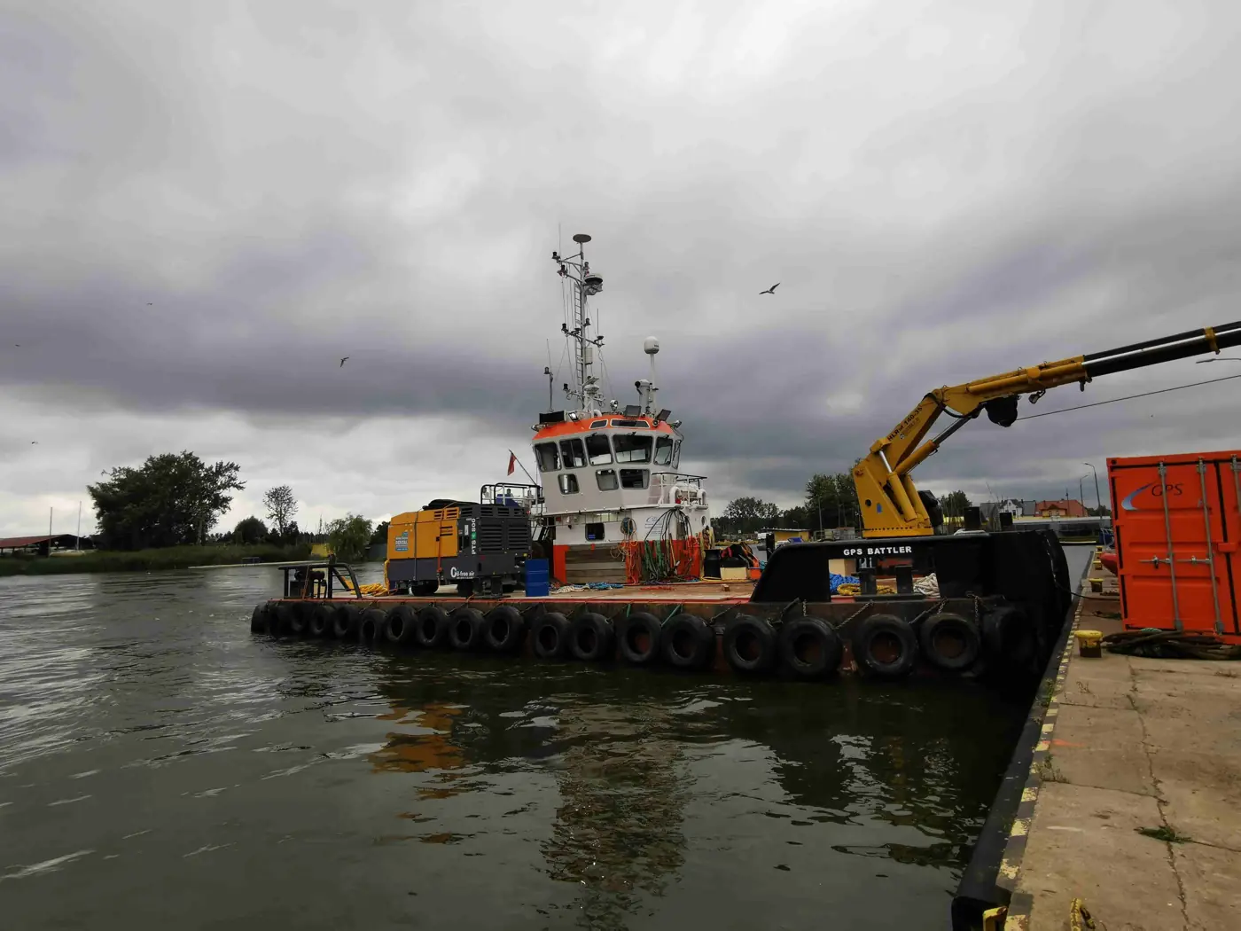 Working vessel alongside a quay
